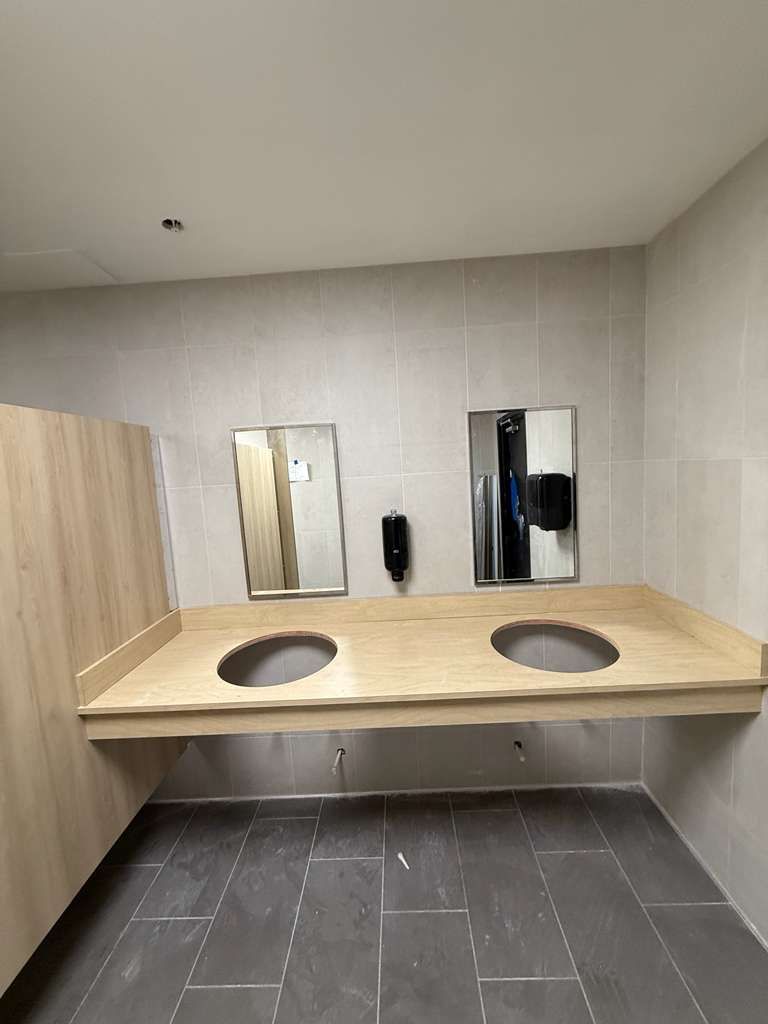 Installed solid HDPE toilet partitions and vandal-proof anti-fog mirrors at Matter Academy School restrooms