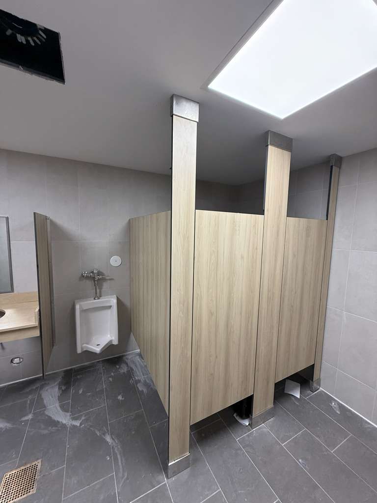 Urinal privacy panels with secure continuous stainless steel brackets