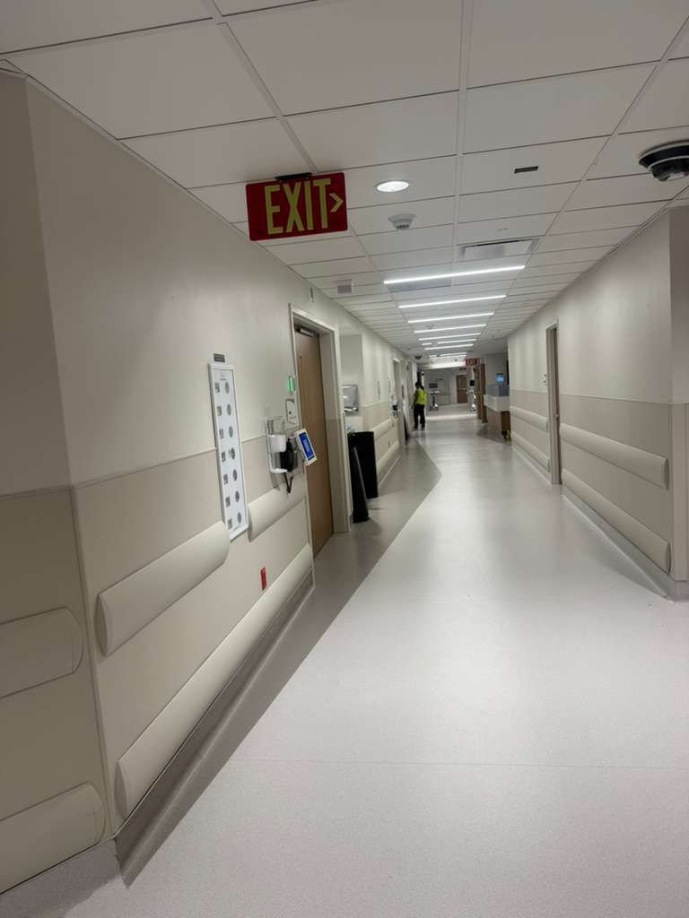 Class A fire-rated wall protection sheets with dual-laser alignment in patient corridor