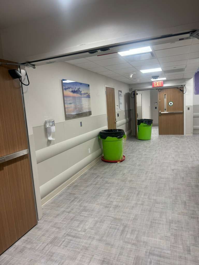 Finished hospital hallway with fully ADA-compliant wall handrails